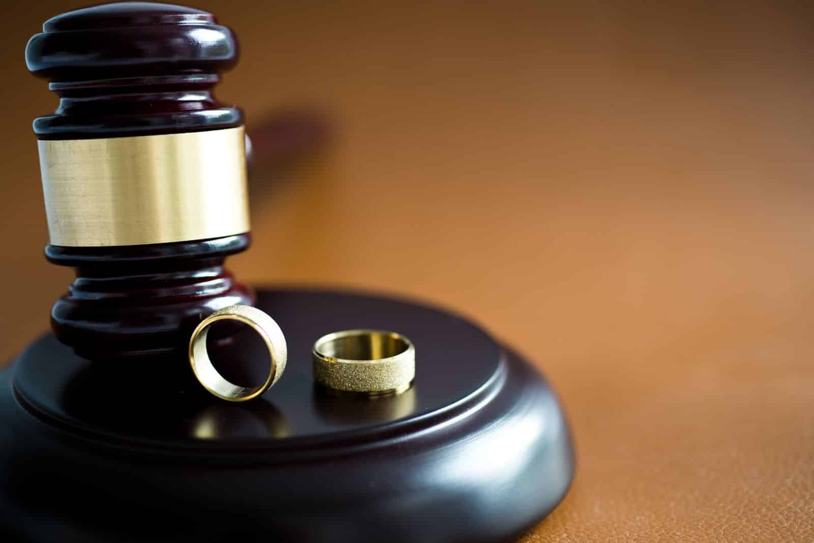 Two weddings rings standing on a Judges Gavel